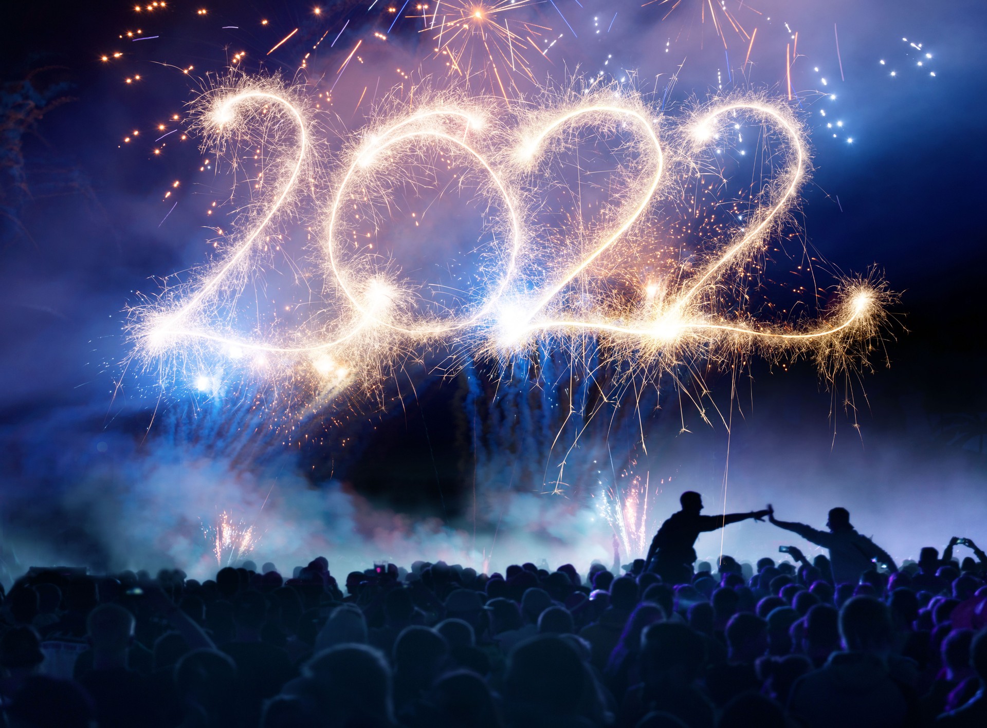 Crowd in front of vibrant firework with sparklers - lettering 2022